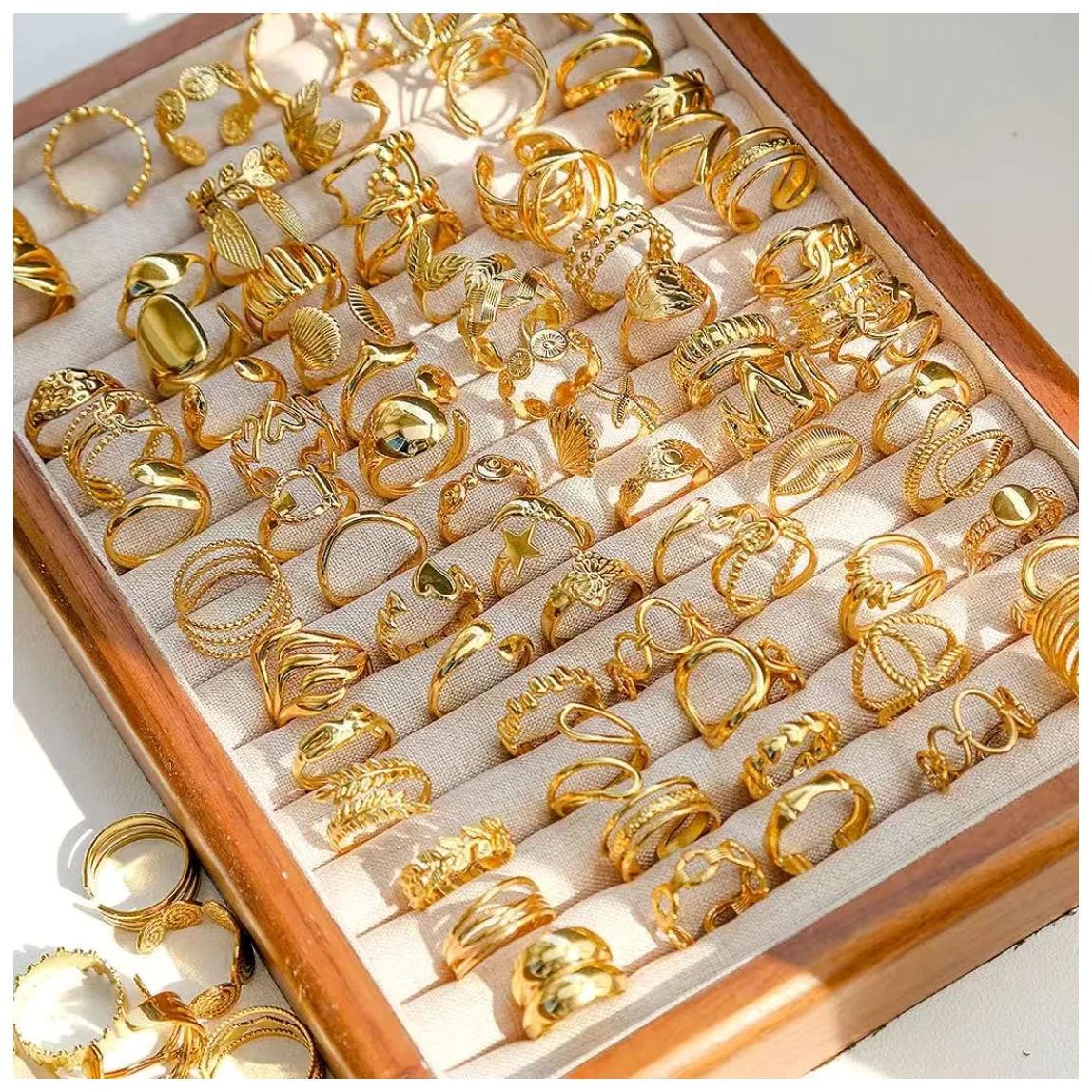 A dense tray of gold-tone ring styles