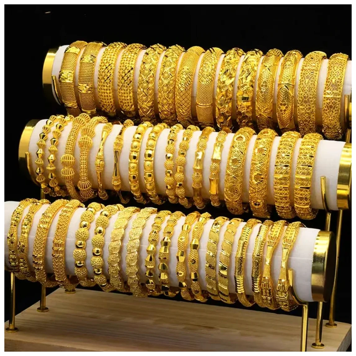 Gold-tone bangles arranged across display rolls