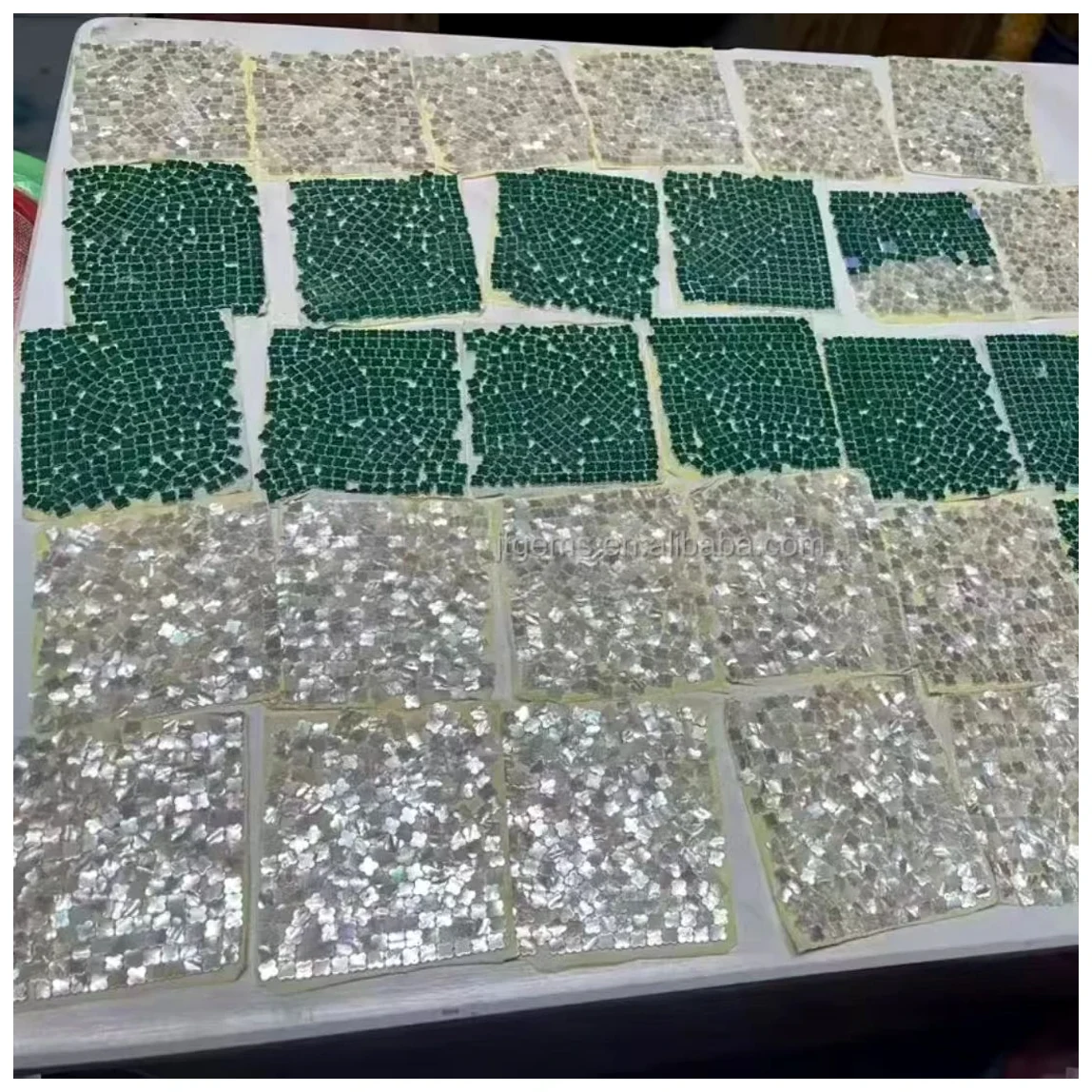 Green and clear stone stock organized in trays